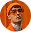 Man wearing glasses and a brown jacket against an orange circular background.